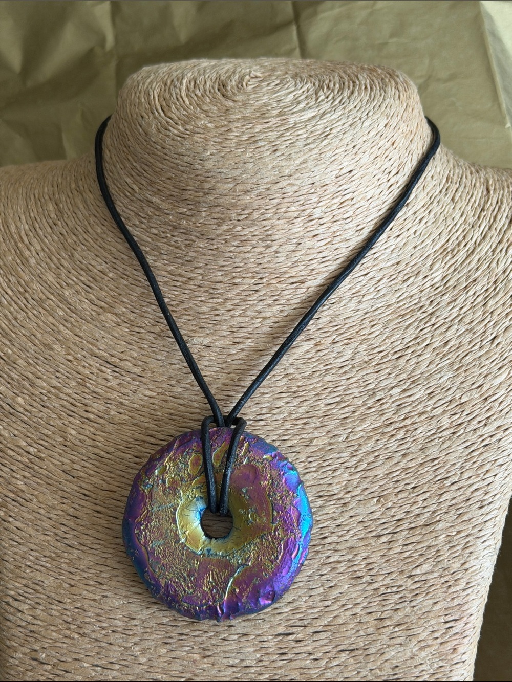 Donut on leather cord 2 1/4” by 2” remarkable color back and front